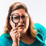 residential client examines service work with magnifying glass